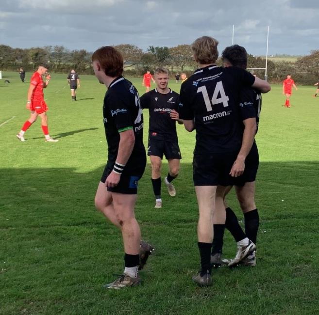 Oli congratulated by team mates. Picture Bill Carne